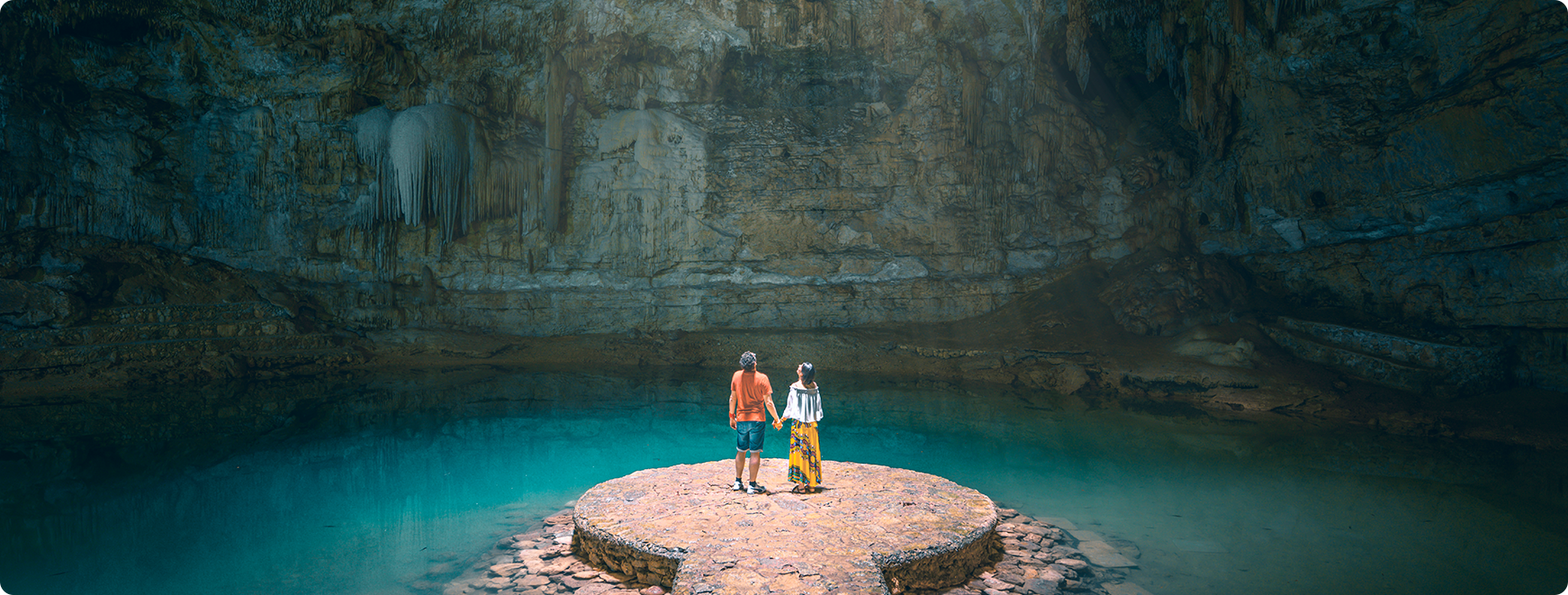 Couple holding hands exploring a canyon